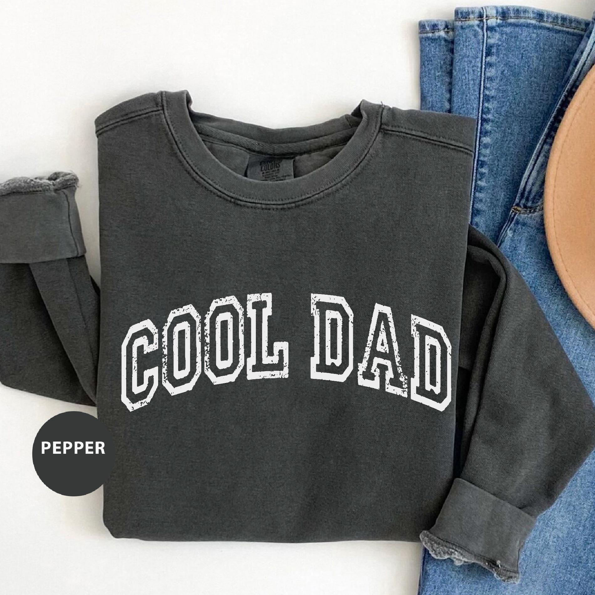 a pair of jeans and a sweatshirt with the word'cool dad'on it