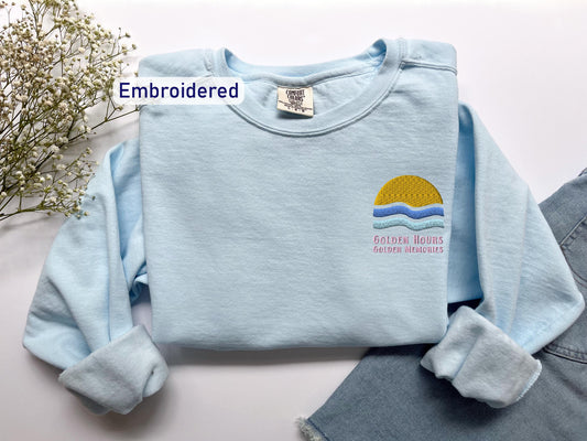a blue shirt with a yellow sun on it