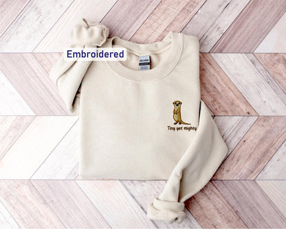 a white sweater with a kangaroo embroidered on it