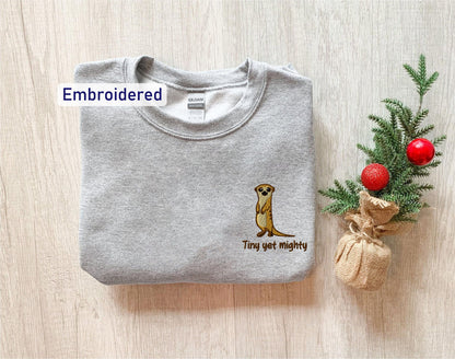 a t - shirt with a kangaroo embroidered on it next to a christmas tree