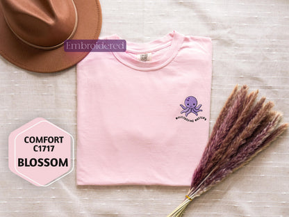 a pink shirt with a purple octopus on it