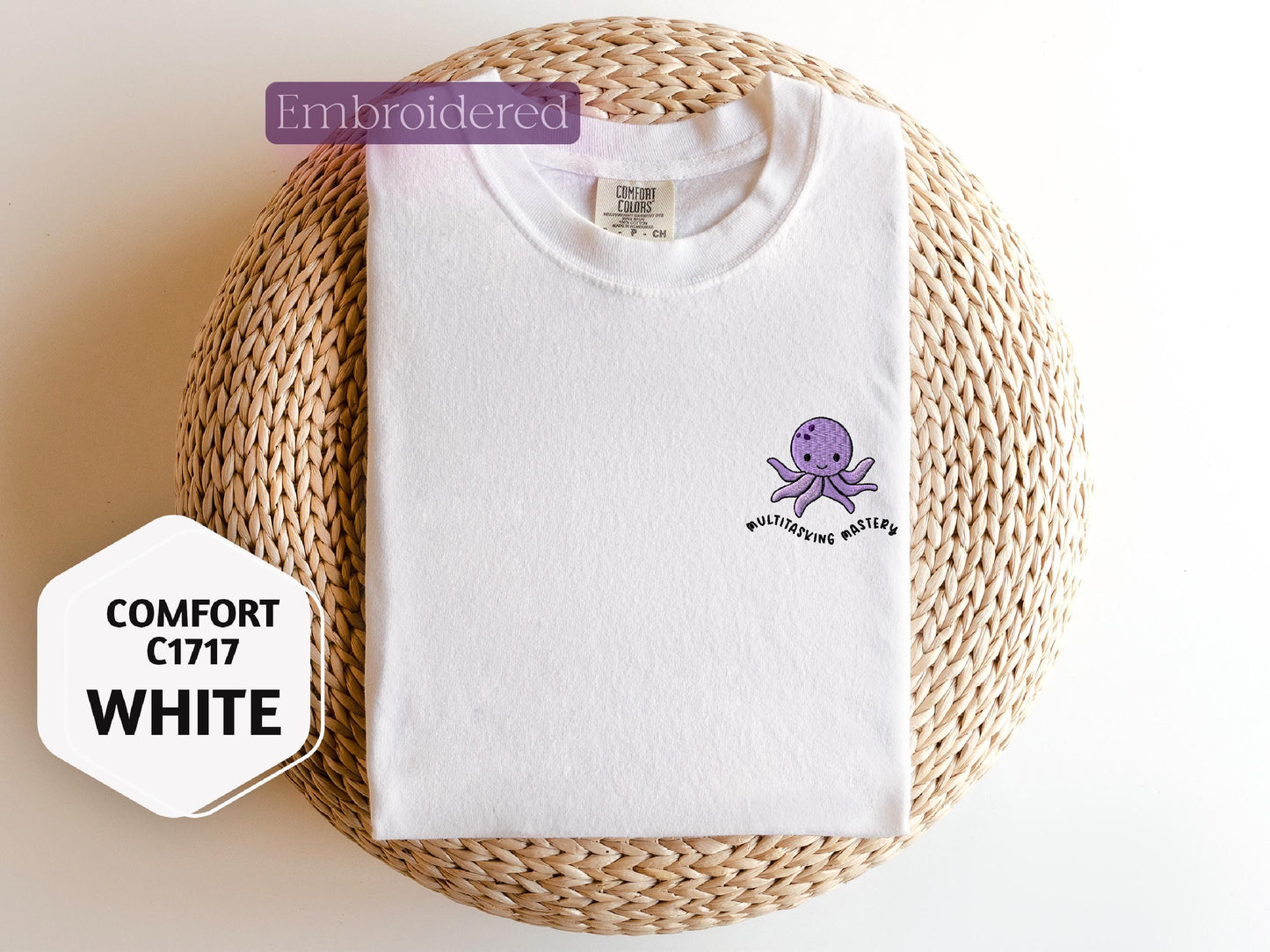 a white shirt with a purple octopus on it