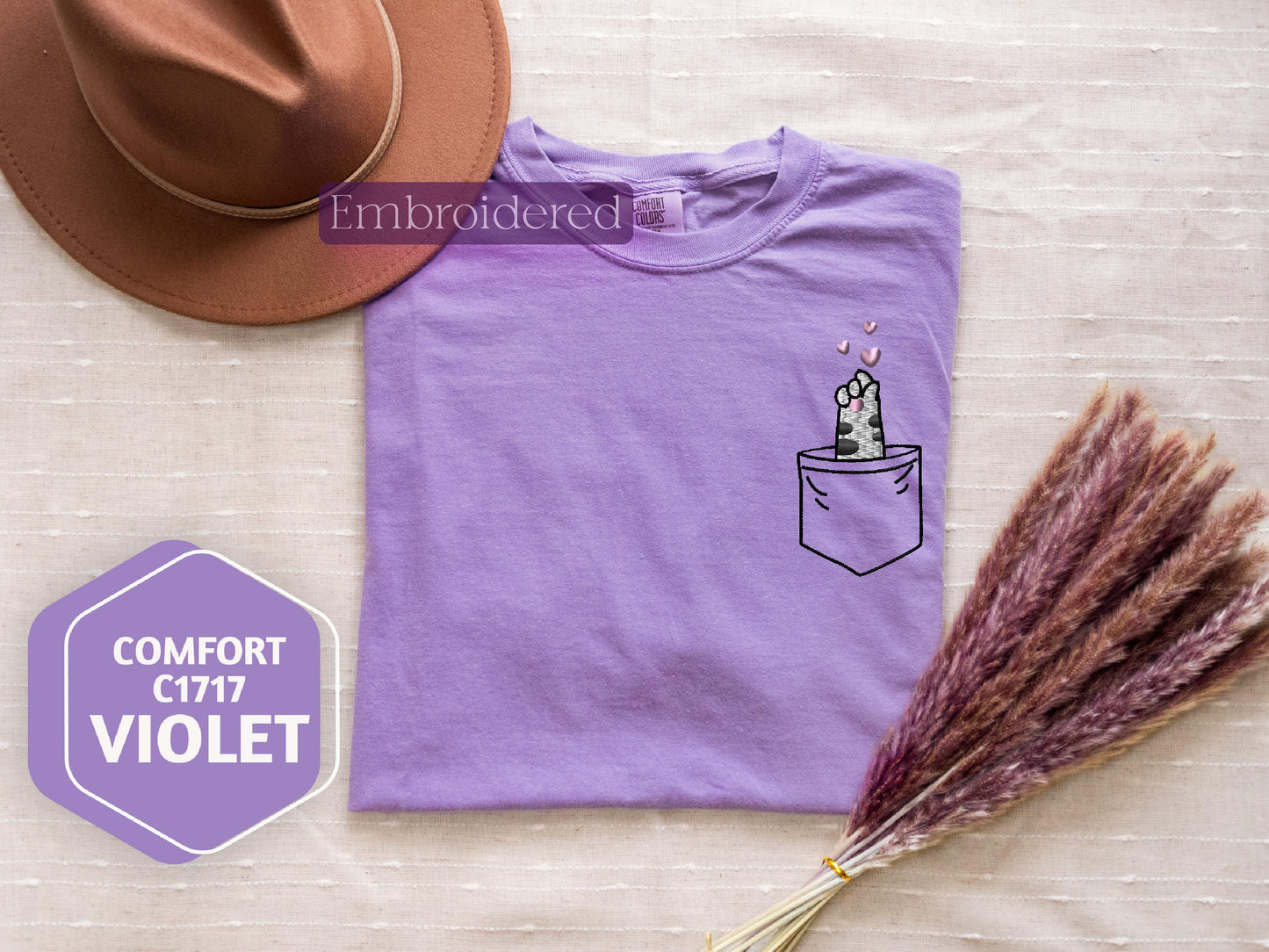 a purple t - shirt with a cactus in a pocket on it