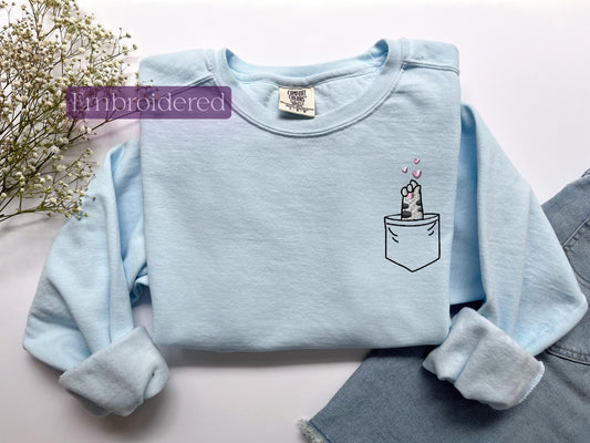 a blue shirt with a picture of a cake in the pocket