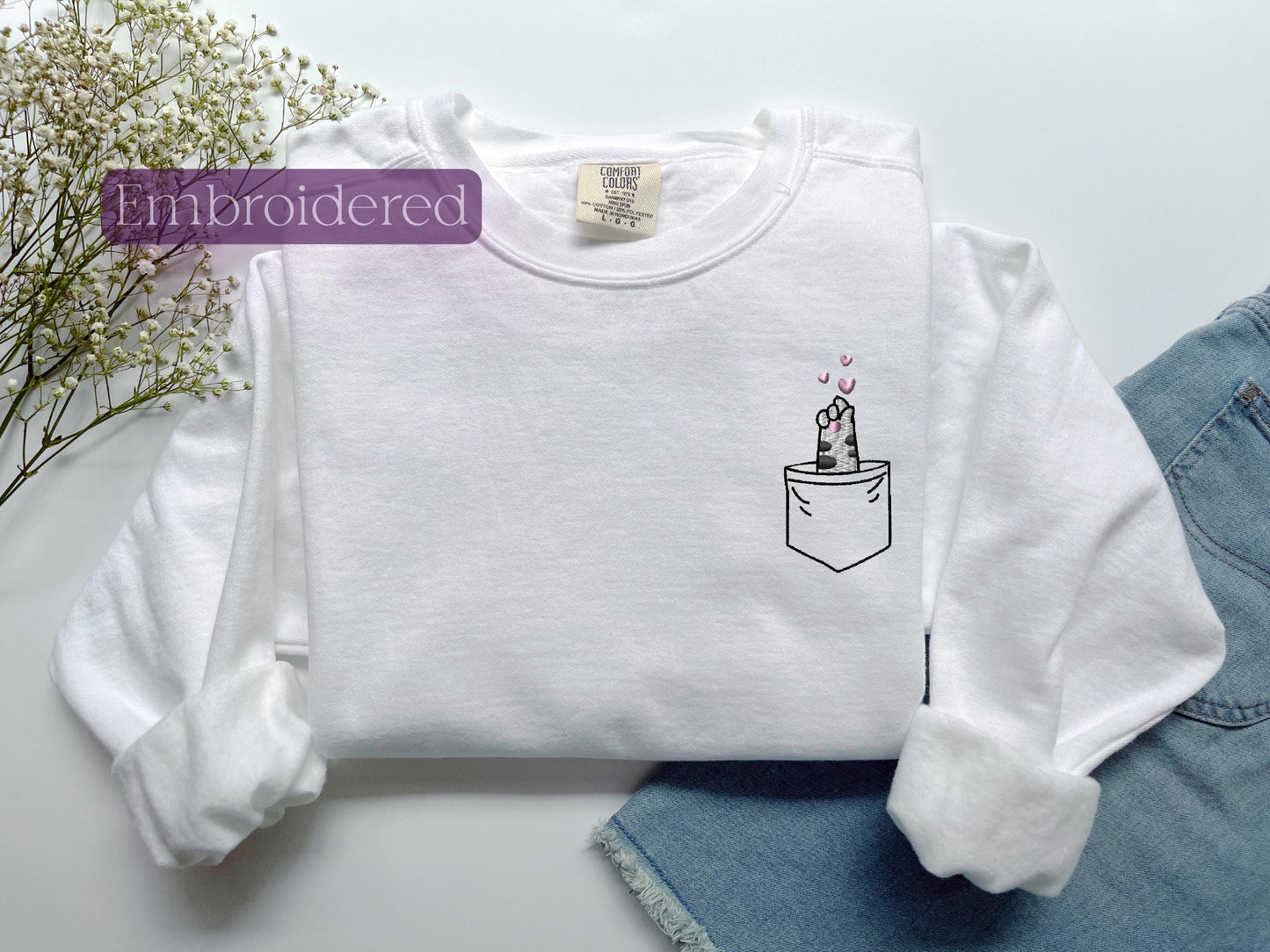 a white shirt with a picture of a cake in a pocket