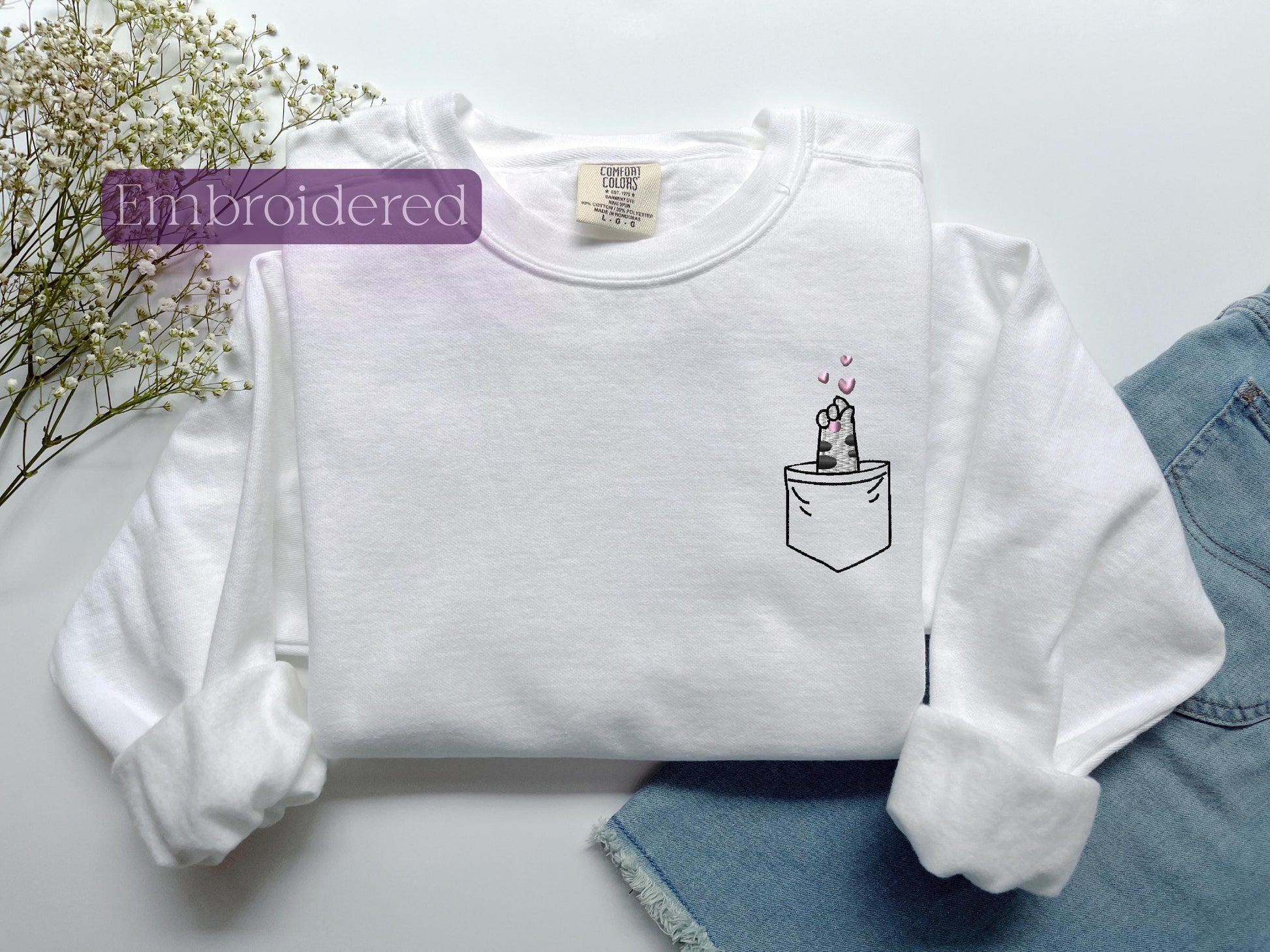 a white shirt with a picture of a cake in a pocket