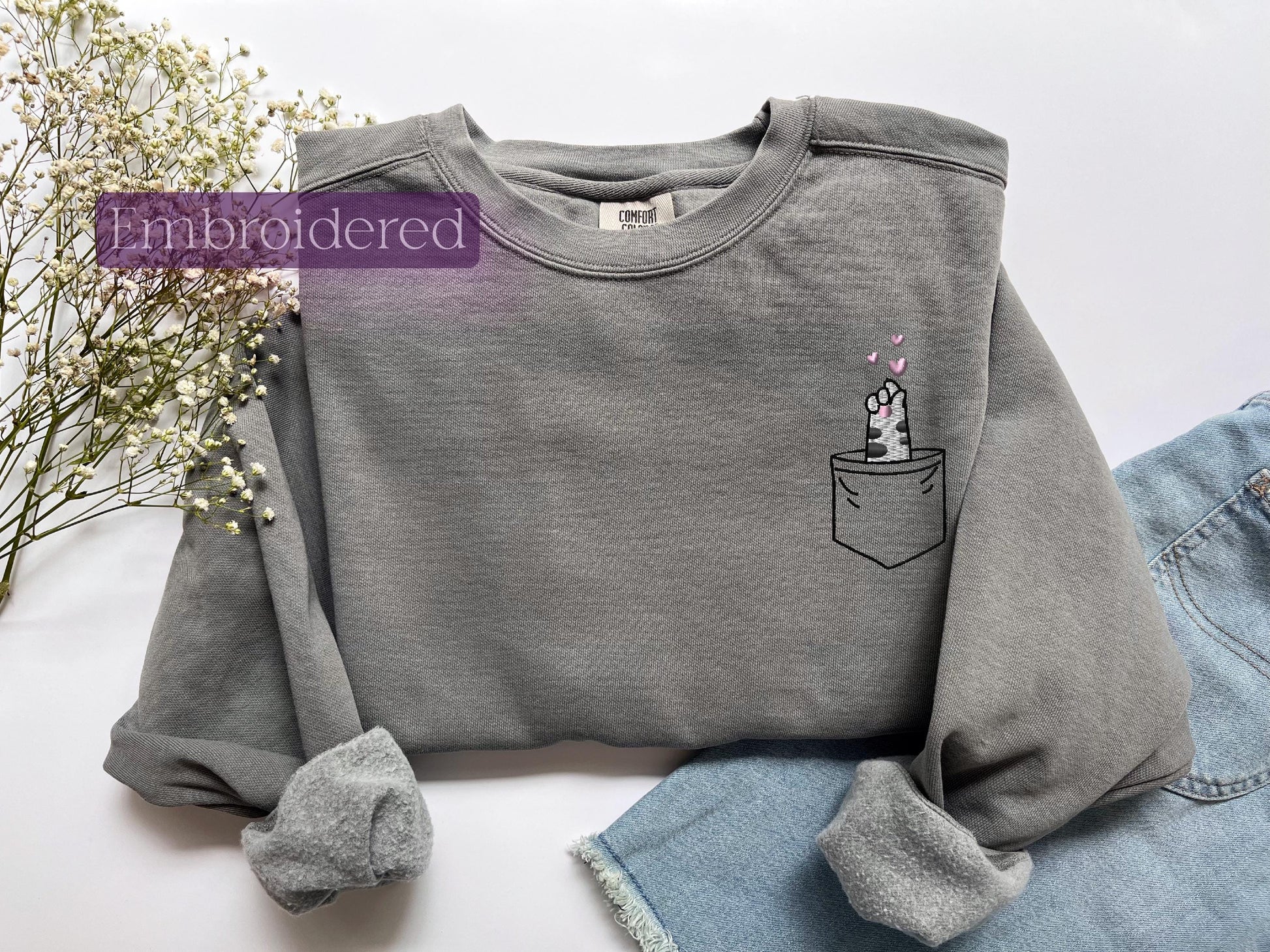a gray shirt with a unicorn in a pocket on it
