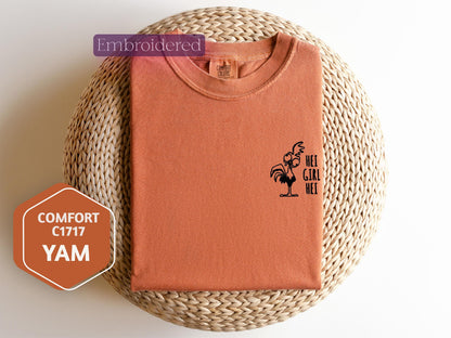 an orange shirt with a rooster on it