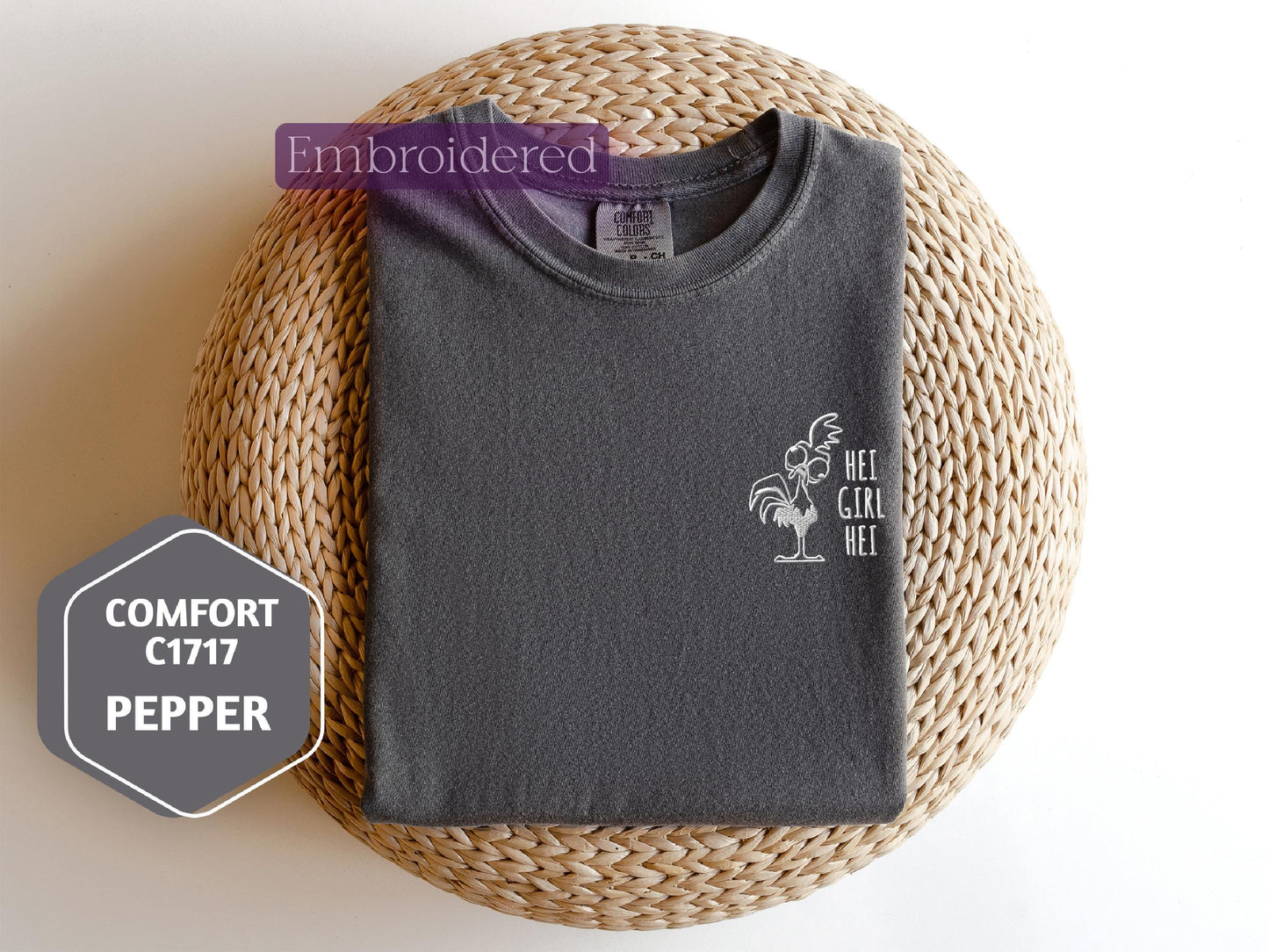 a gray t - shirt sitting on top of a wicker basket