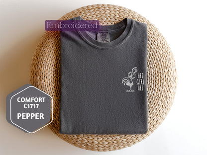 a gray t - shirt sitting on top of a wicker basket