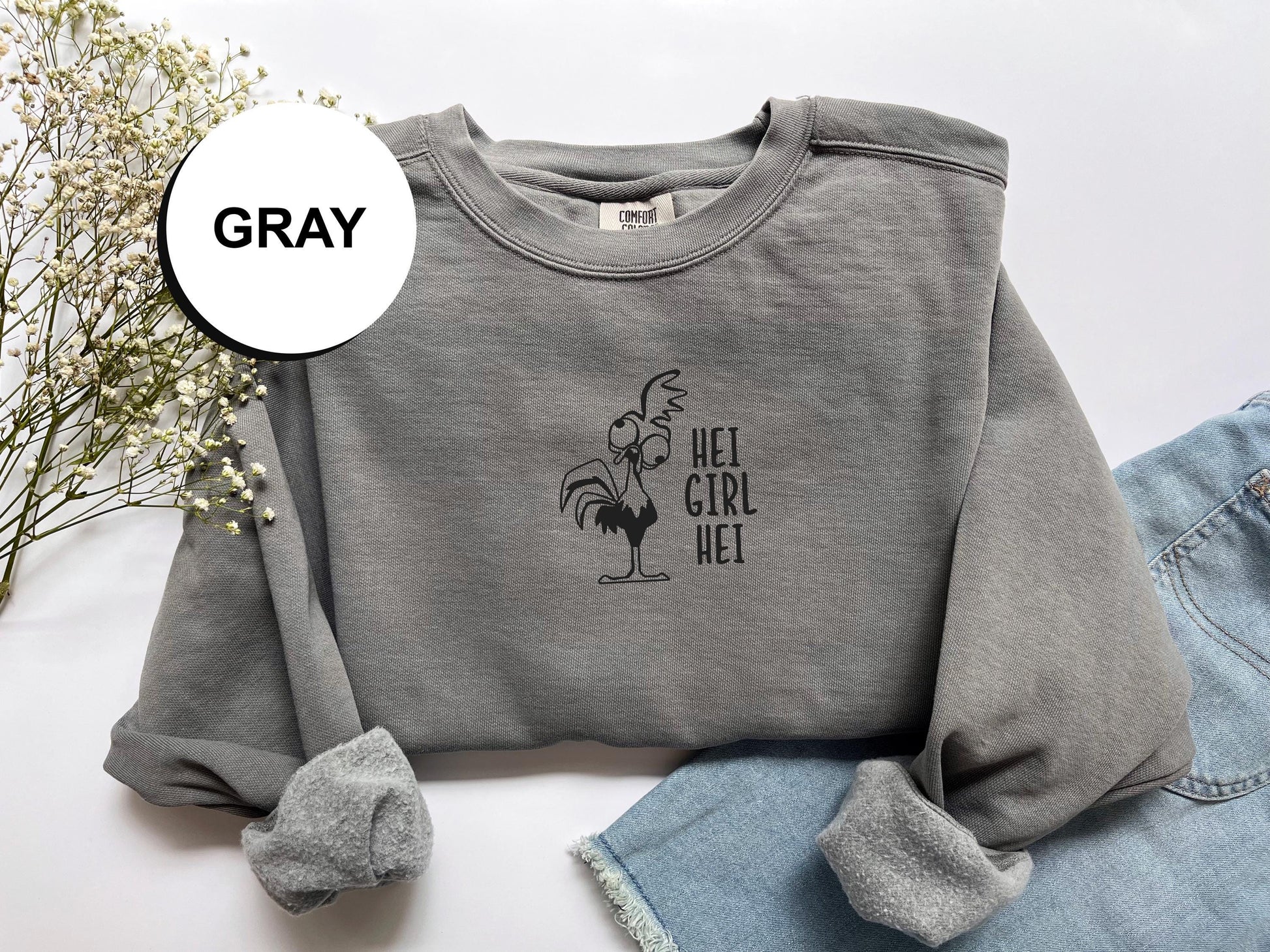 a gray sweatshirt with a picture of a rooster on it