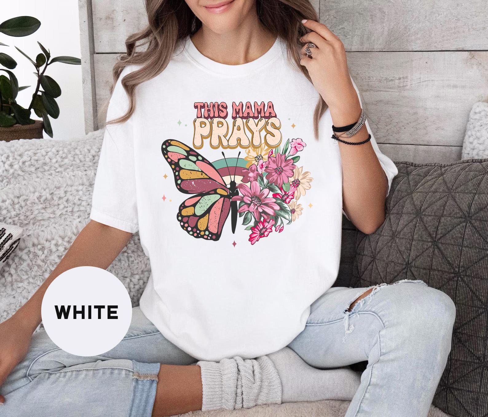 a woman sitting on a couch wearing a white t - shirt