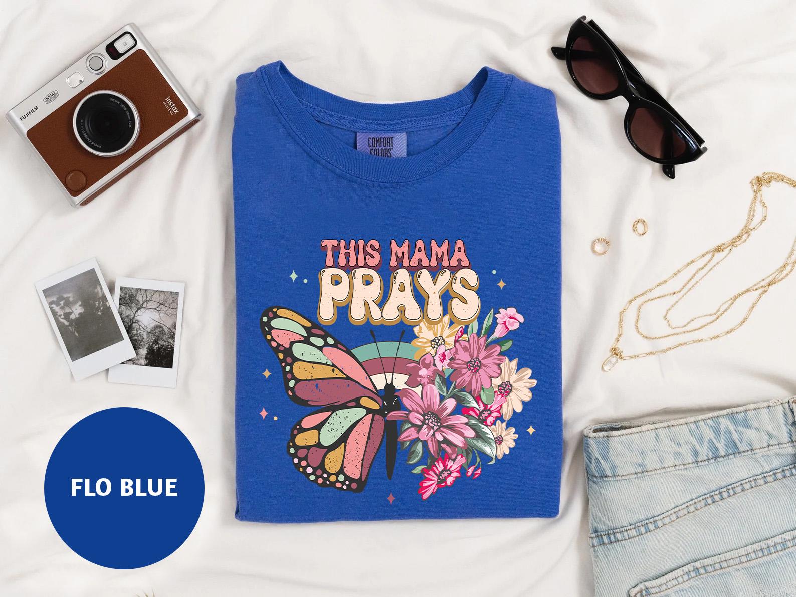 a t - shirt with a picture of a butterfly and flowers on it