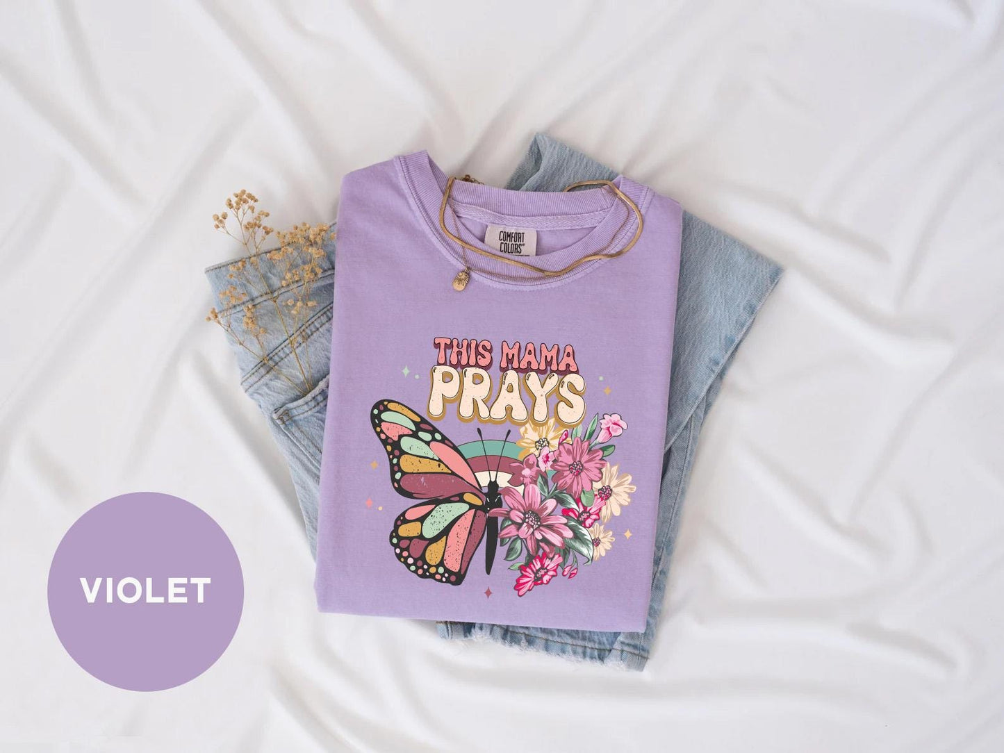 a purple shirt with a butterfly on it