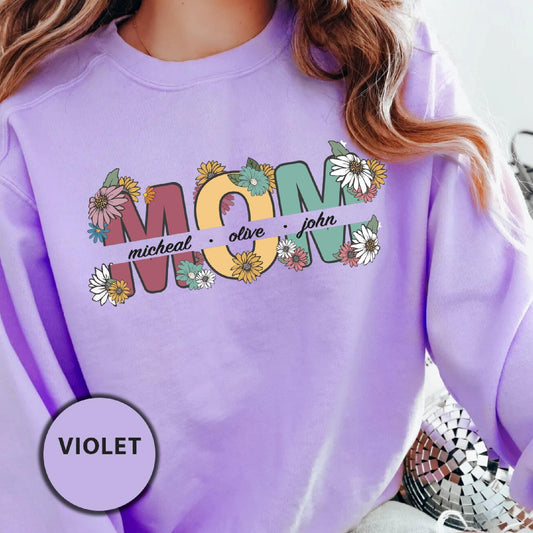 a woman wearing a purple sweatshirt with the word mom printed on it