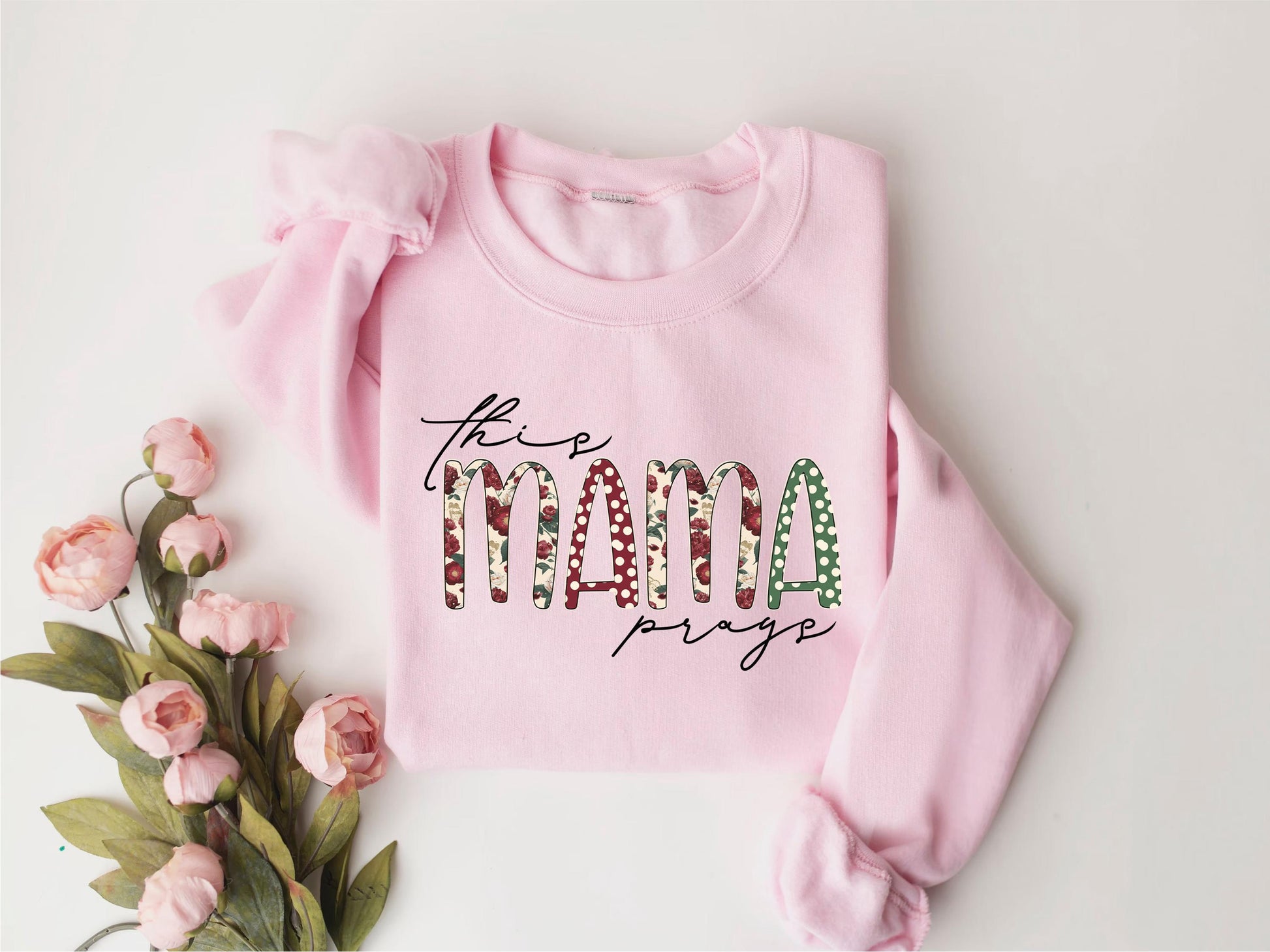 a pink sweater with the word mama on it