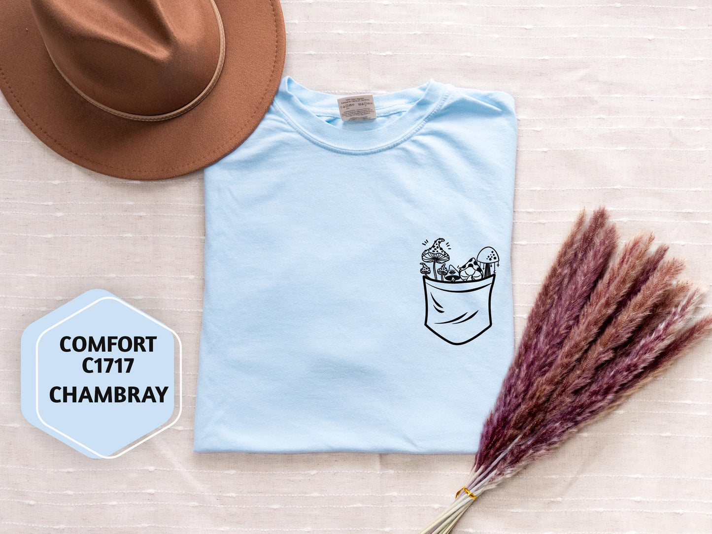 a hat, t - shirt, and dried grass on a table