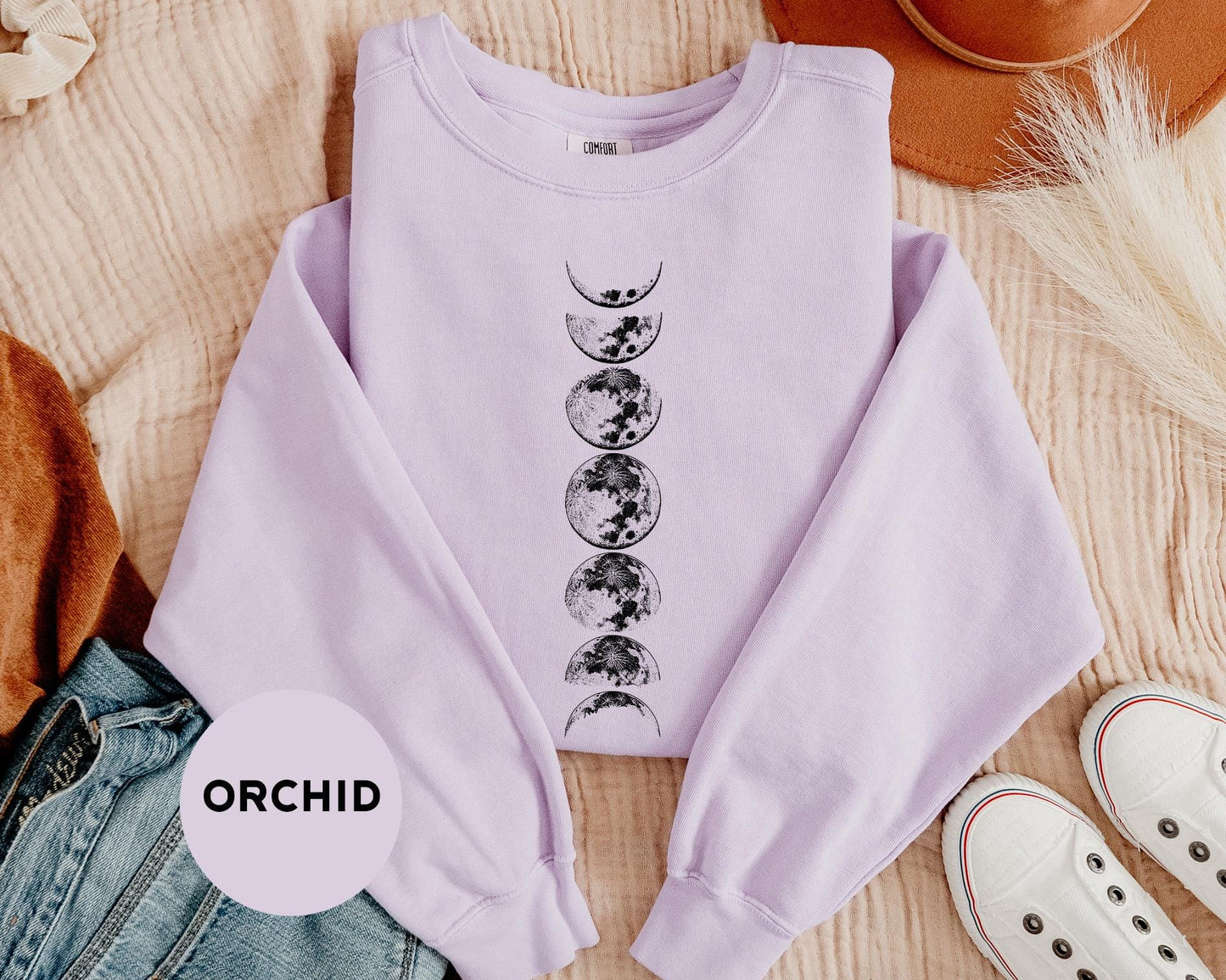a purple shirt with the phases of the moon on it