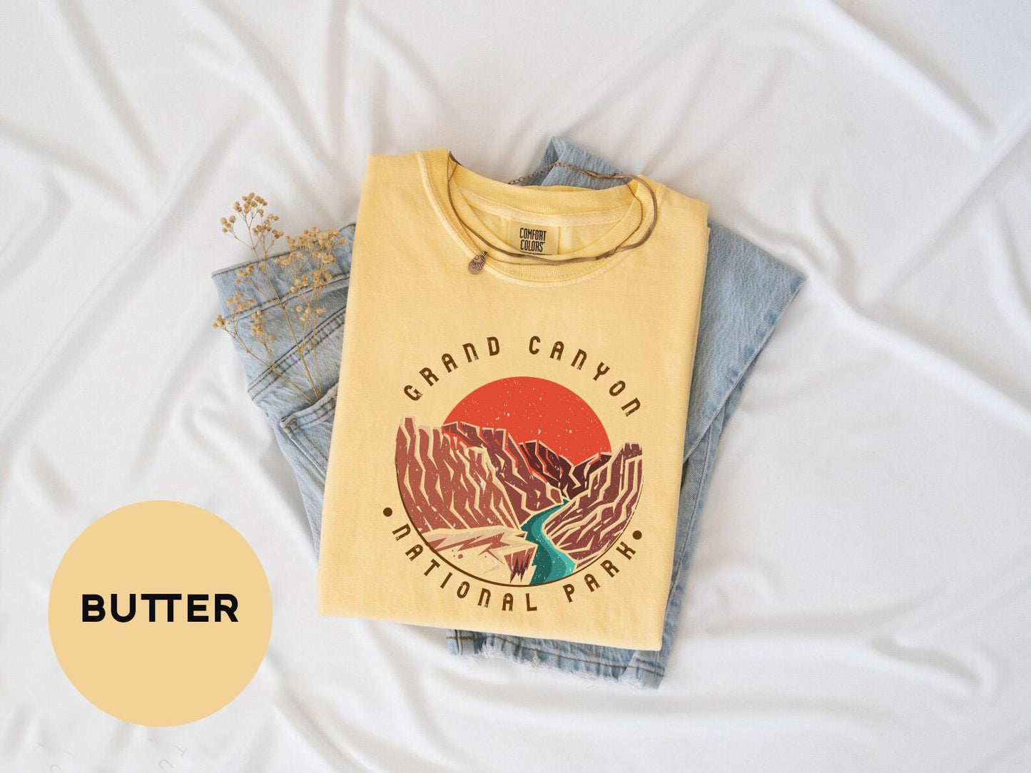 a yellow shirt with a picture of a mountain on it