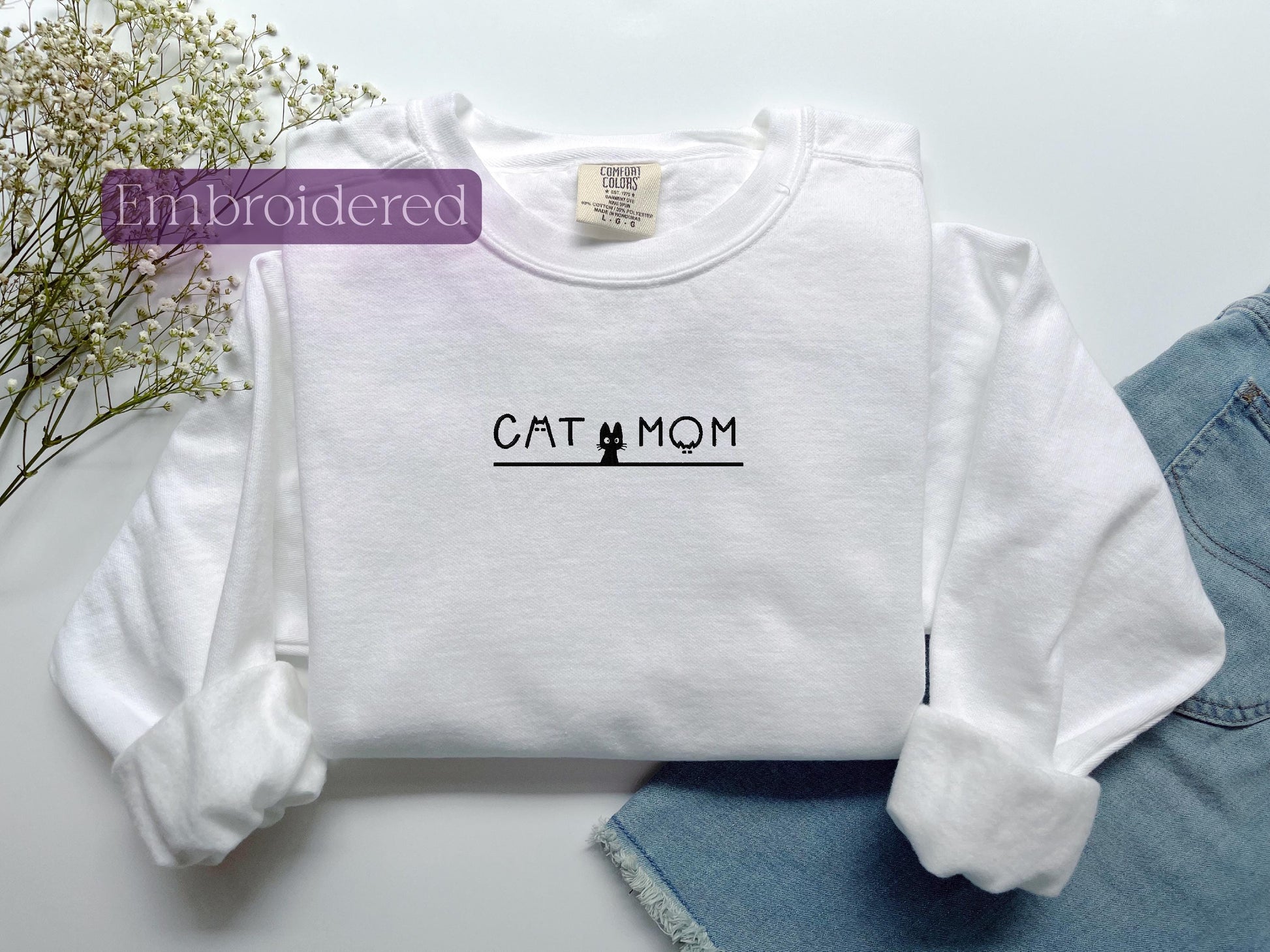 a white shirt with the word cat mom on it
