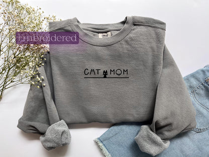 a gray sweatshirt with the word cat mom printed on it