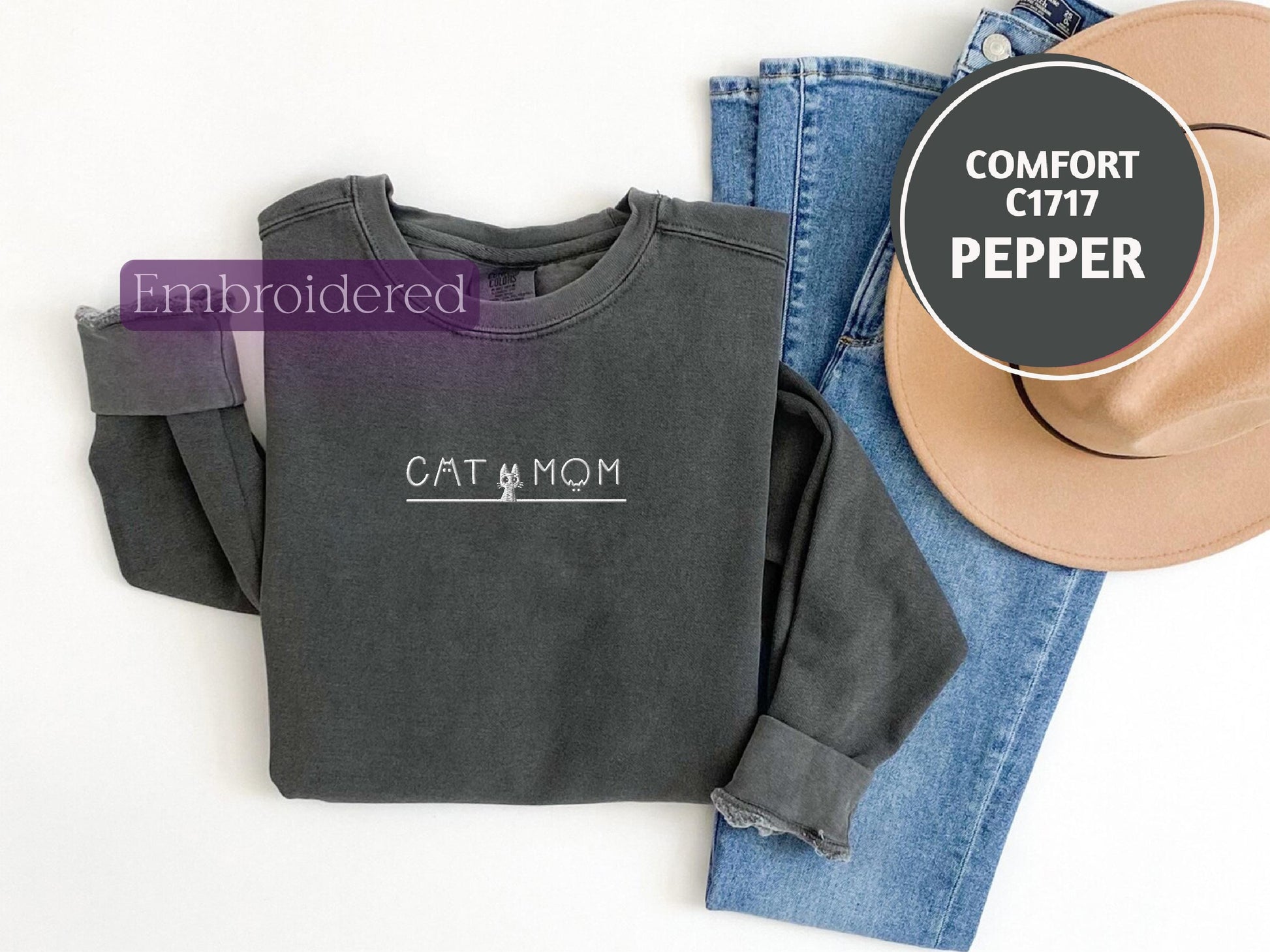 a pair of jeans, a hat, and a sweatshirt