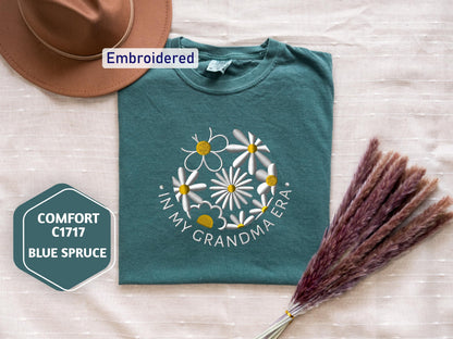a hat, t - shirt, and broom on a bed