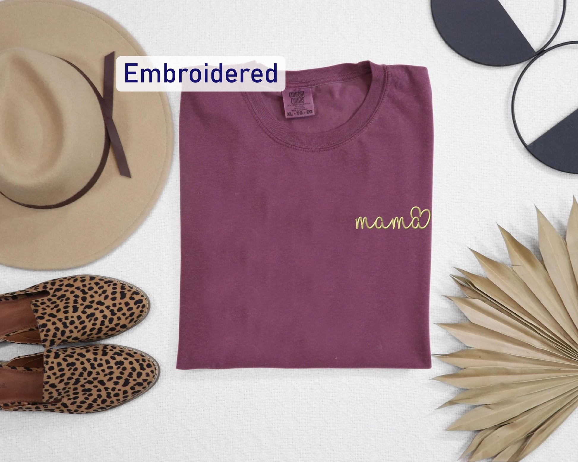 a t - shirt, hat, palm leaves, and a pair of slippers