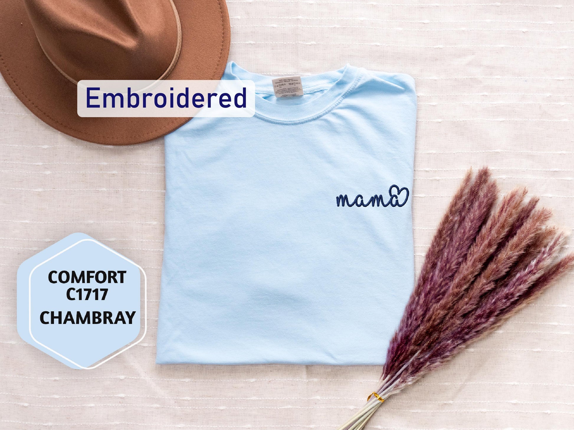 a hat, t - shirt, and a feather on a table