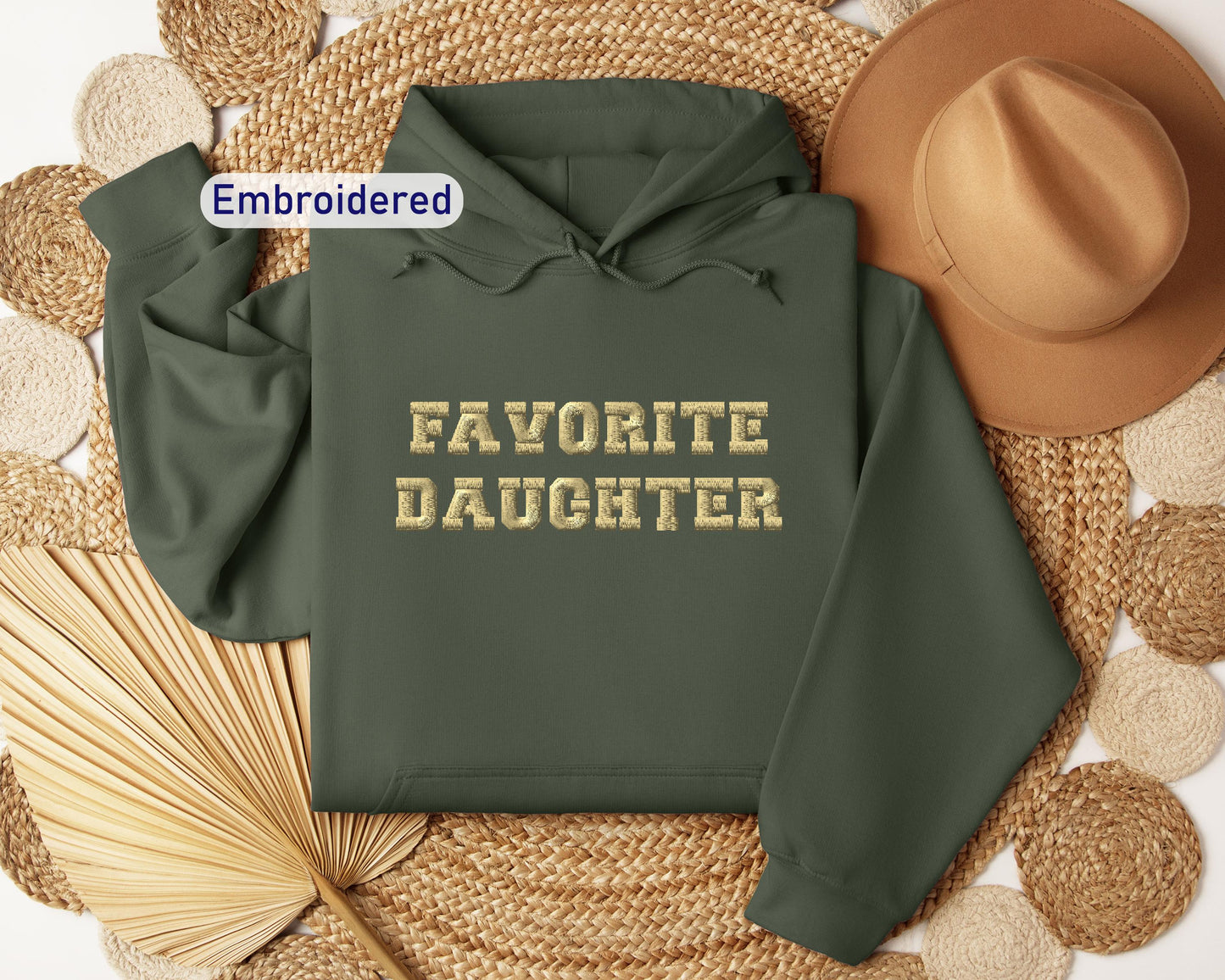 a green hoodie with the words favorite daughter on it