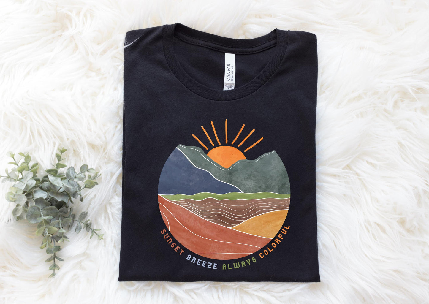 a black t - shirt with a mountain scene on it