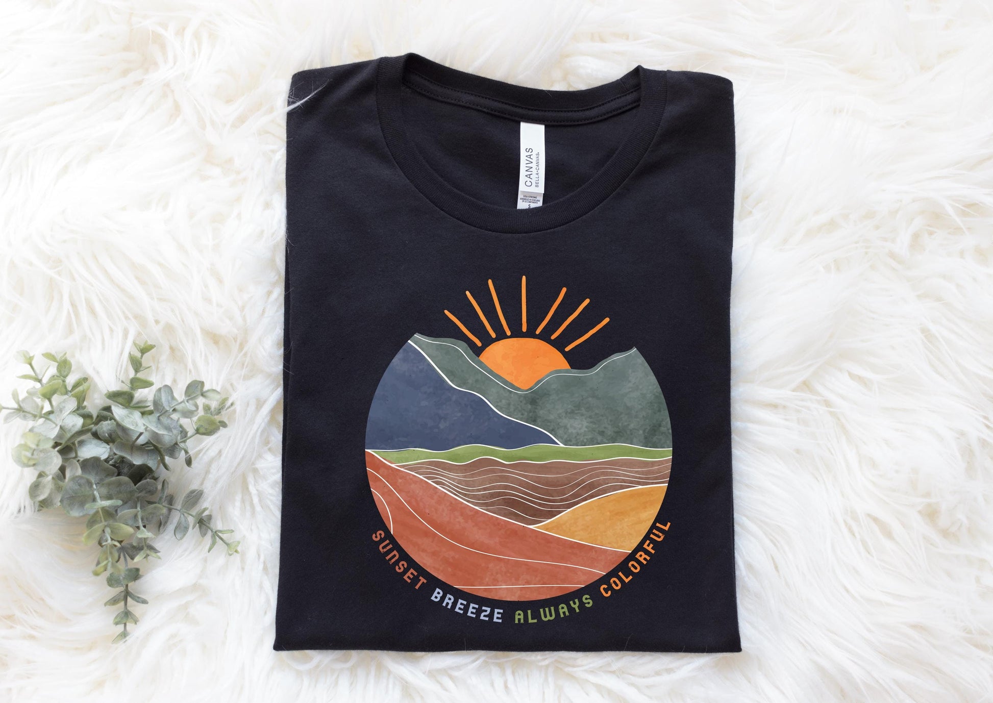 a black t - shirt with a mountain scene on it