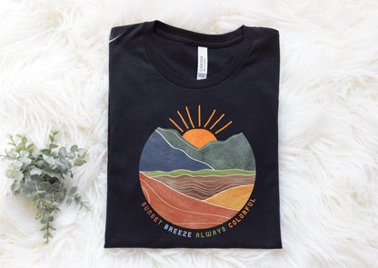 a black t - shirt with a mountain scene on it