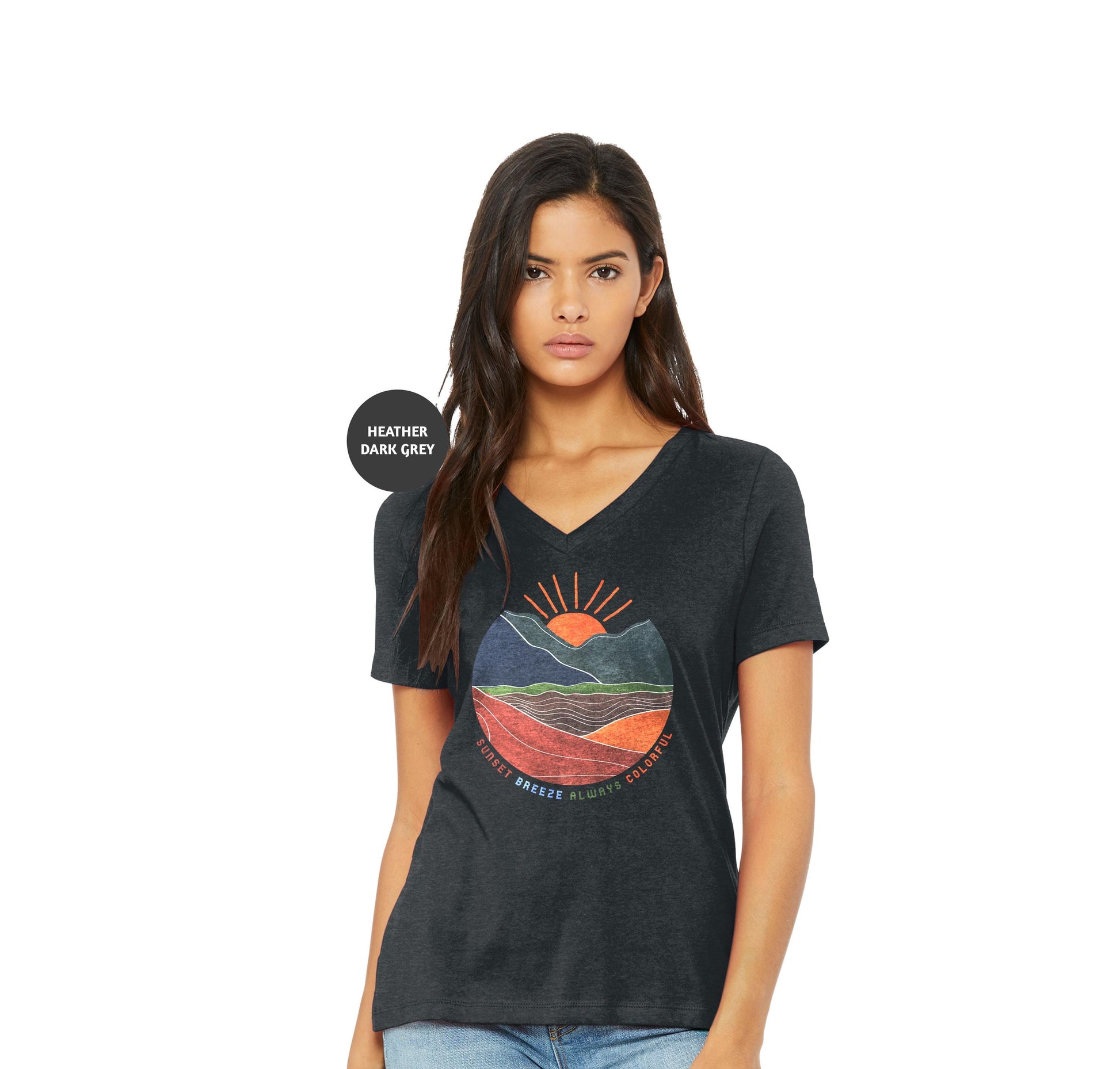a woman wearing a black t - shirt with a sunset graphic on it