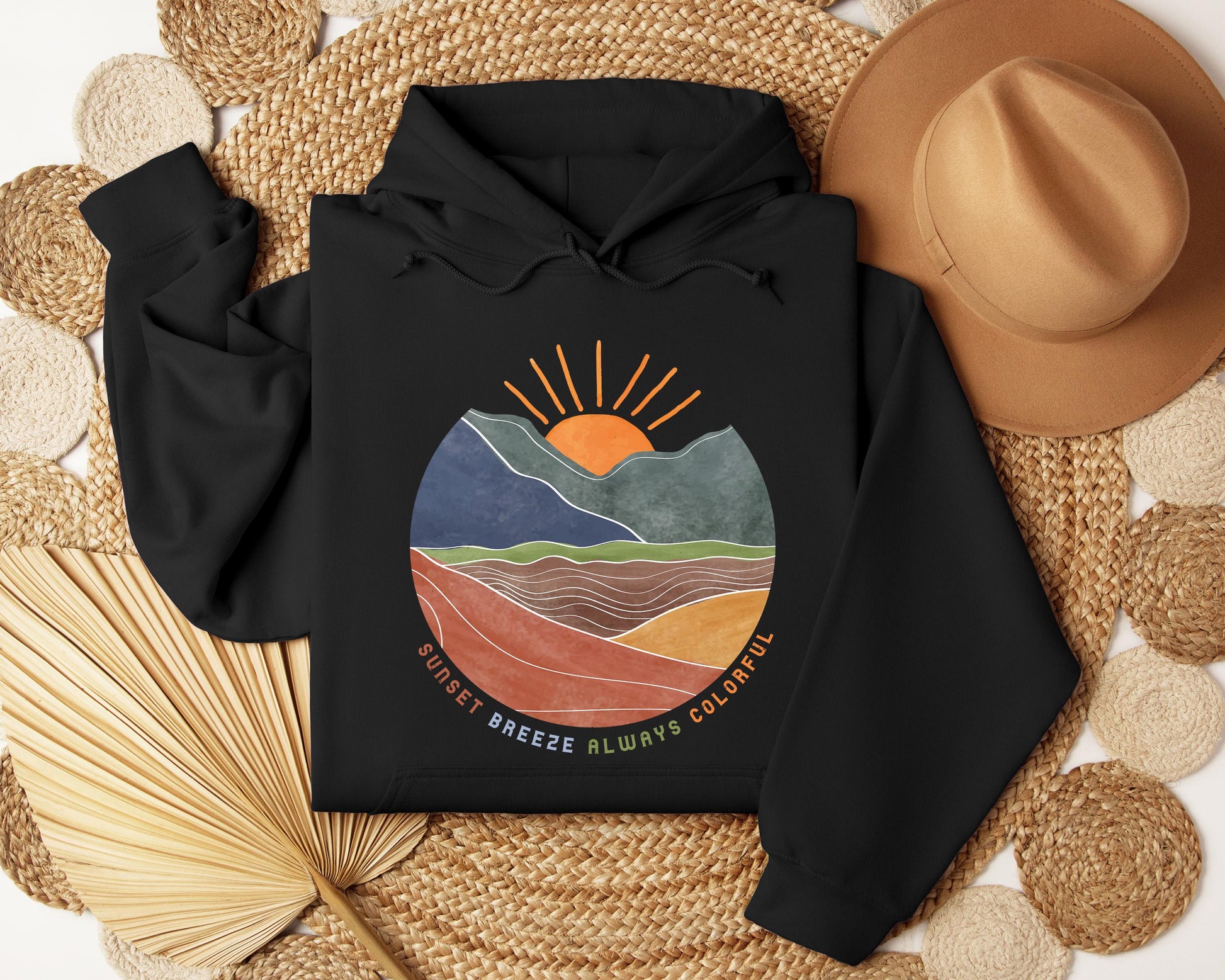 a black hoodie with a mountain scene on it