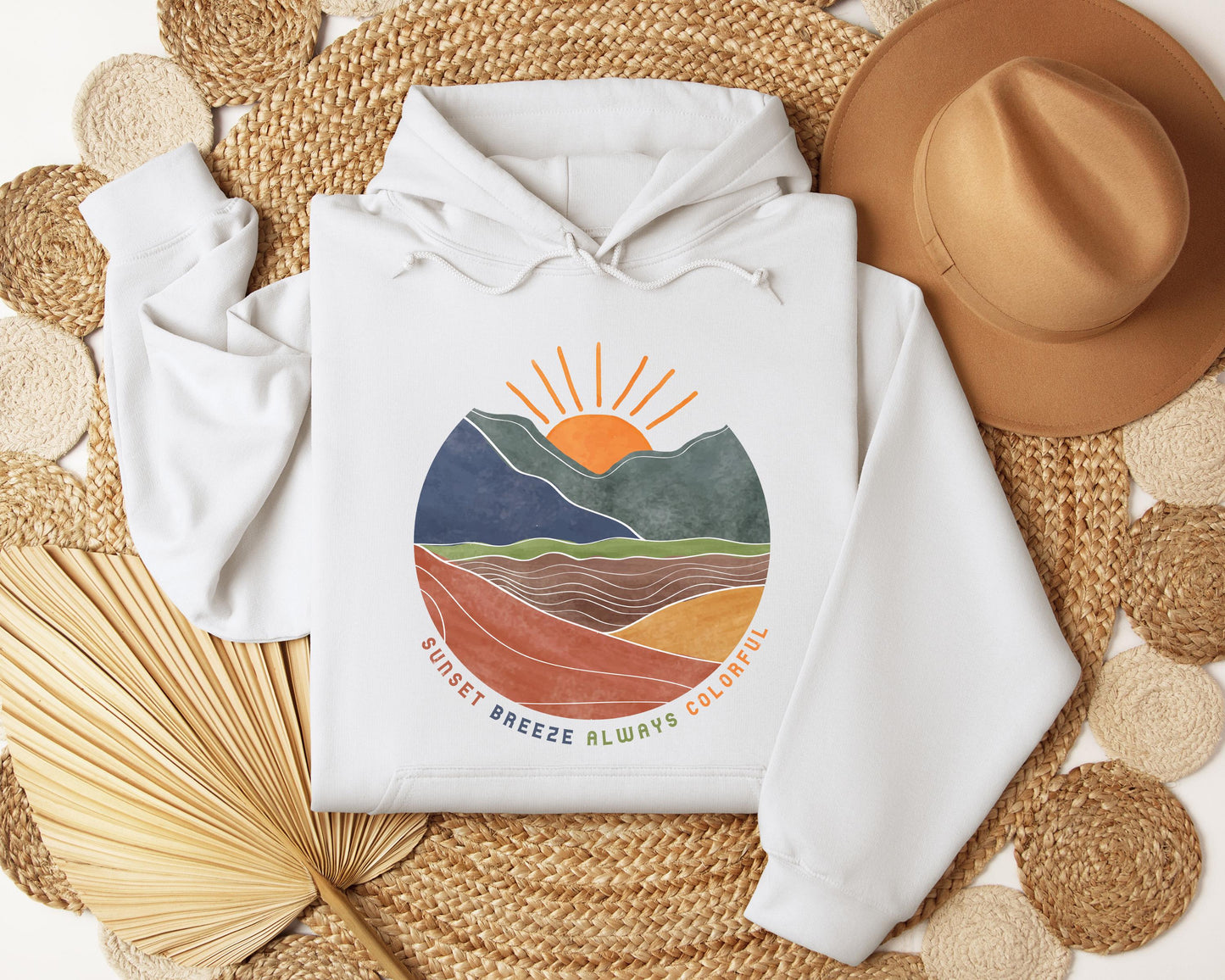 a white hoodie with a mountain scene on it