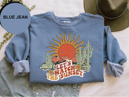 a blue jean shirt with the words let's watch the sunset on it