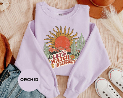 a purple shirt with a picture of a sun on it