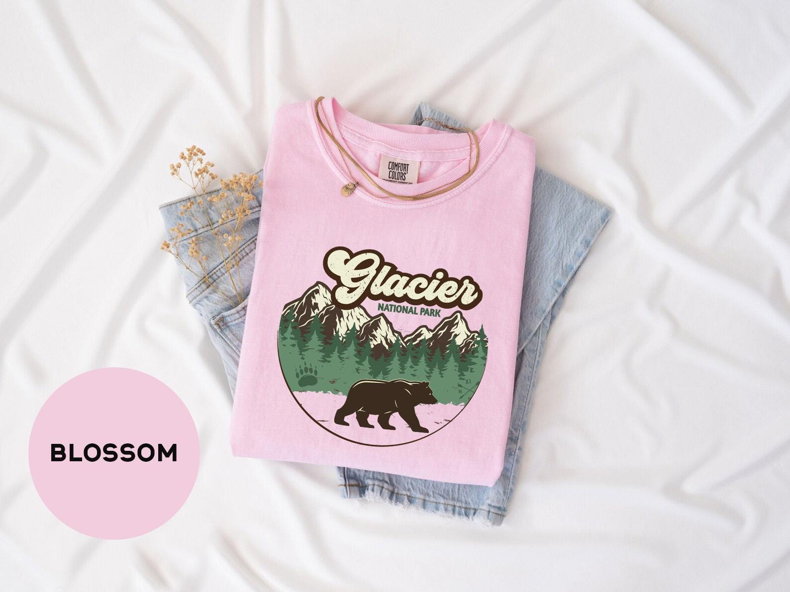 a pink shirt with a bear on it