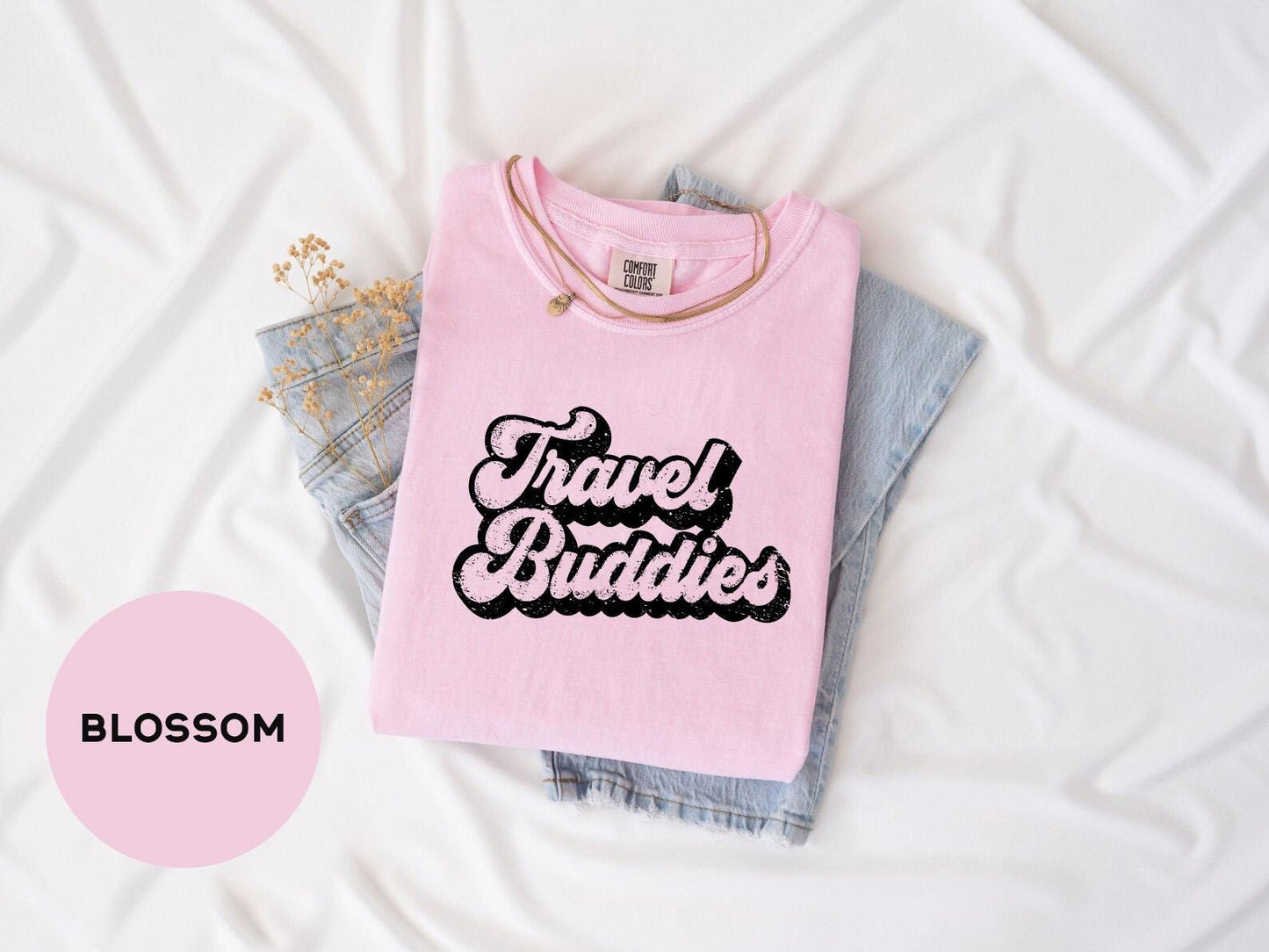 a pink shirt that says travel buddies on it