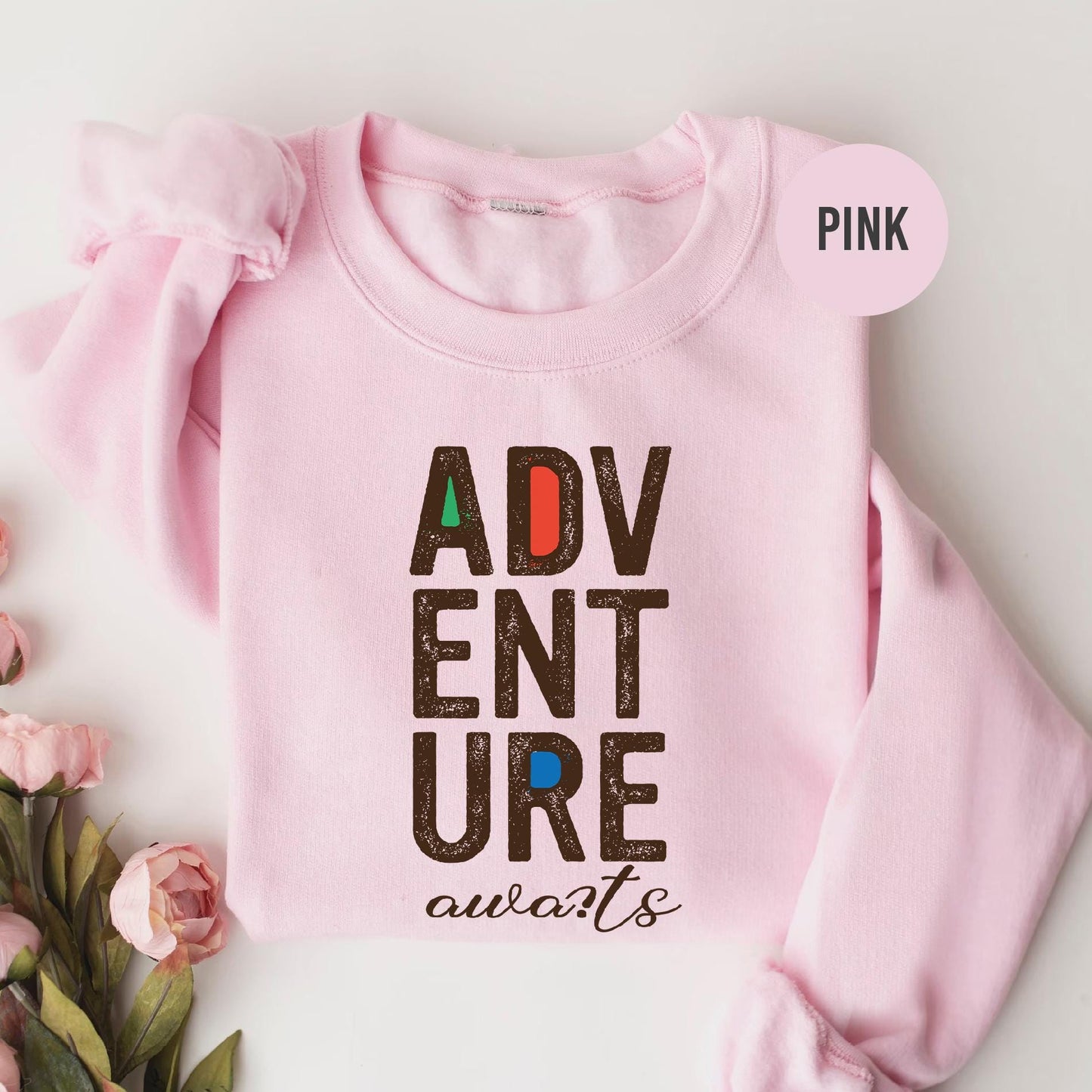 a pink shirt with the words adventure on it