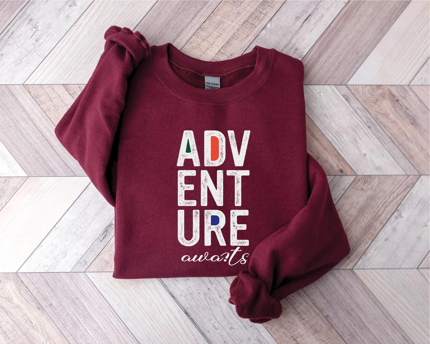 a red sweatshirt with the words adv ent sure awaits on it