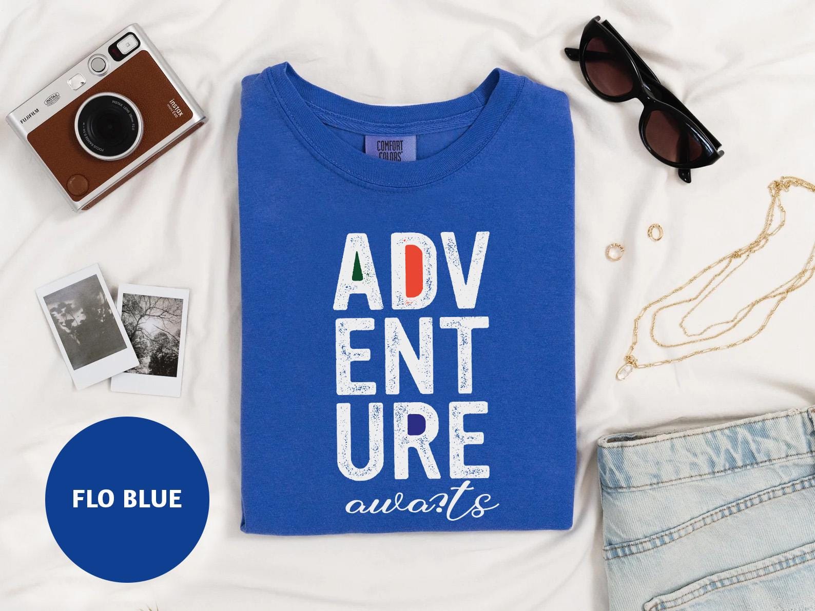 a blue t - shirt that says adv ent sure awaits surrounded by
