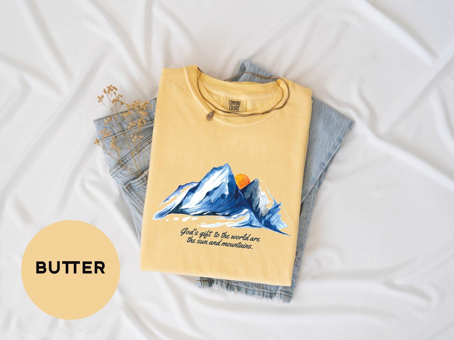 a yellow shirt with a picture of a mountain on it