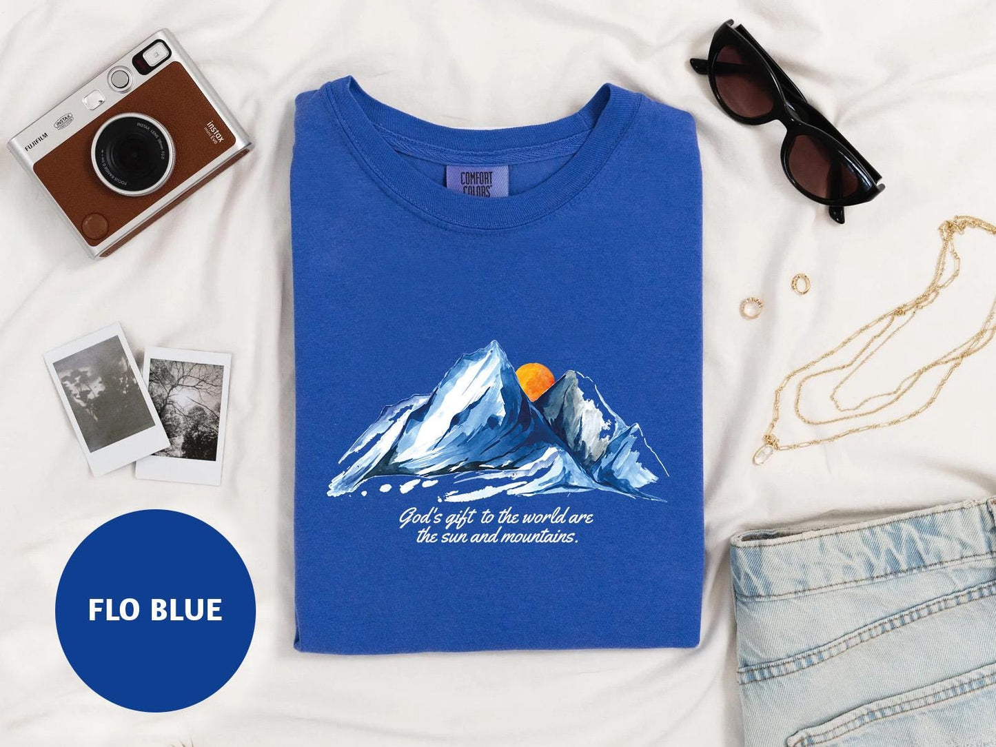 a blue t - shirt with a picture of a mountain on it