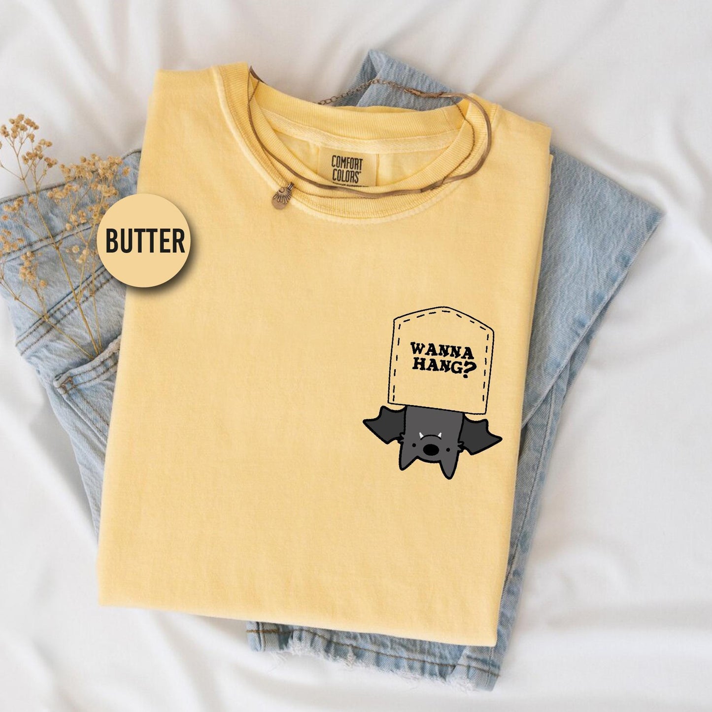 a yellow shirt with a black sticker on it