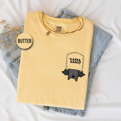 a yellow shirt with a black sticker on it