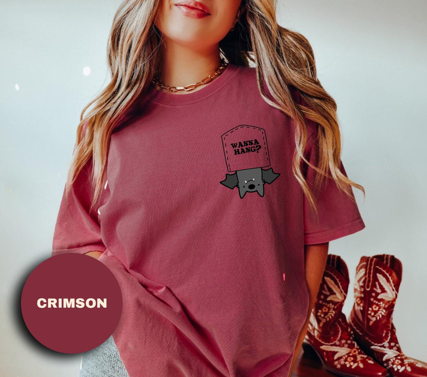 a young girl wearing a red shirt with a graphic on it