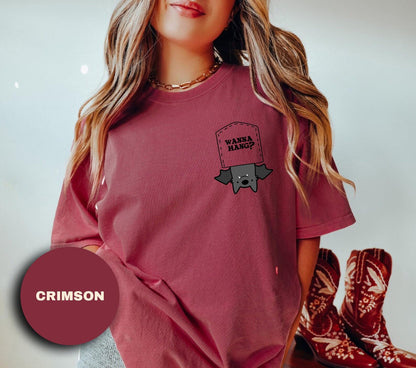 a young girl wearing a red shirt with a graphic on it