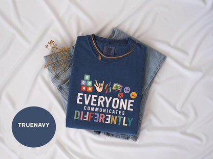 a t - shirt that says everyone communicate differently on it